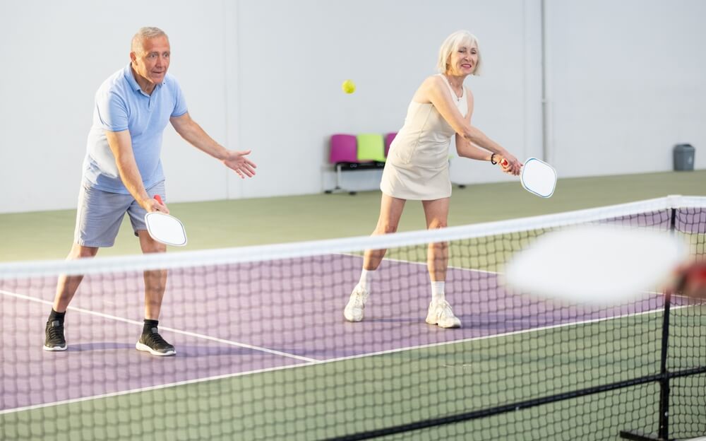 Seniors playing Branson pickleball indoors