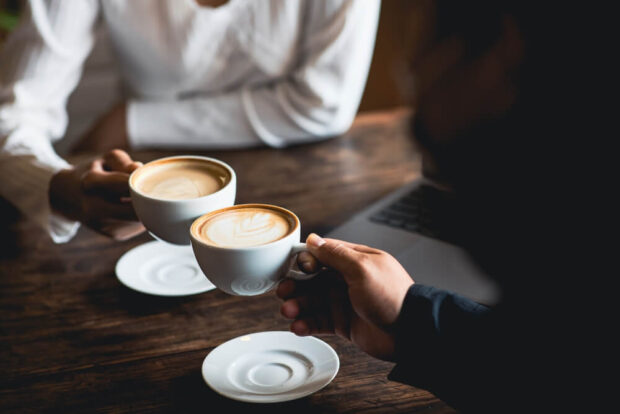 people holding coffee cups at coffee houses in Branson