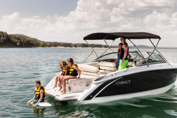Family hanging out on a boat from a marina on Table Rock Lake in Branson