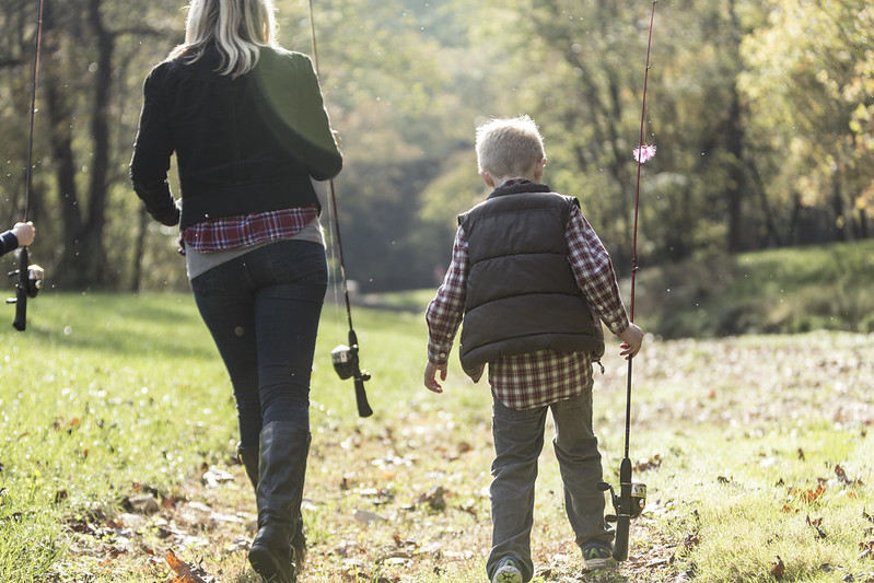 Parent and child enjoying the fall weather in Branson while fishing